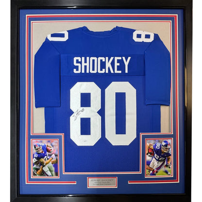 Framed autographed New York Giants blue football jersey with white number 80 signed by Jeremy Shockey with JSA COA