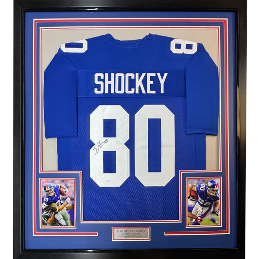 Framed autographed New York Giants blue football jersey with white number 80 signed by Jeremy Shockey with JSA COA