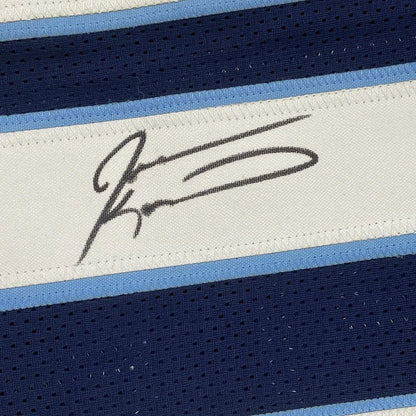 Black ink signature on a white woven label bordered by light blue and navy mesh fabric on tennessee football jersey