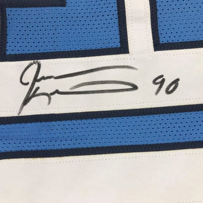 Autographed light blue and white Jevon Kearse Titans jersey with photos in frame