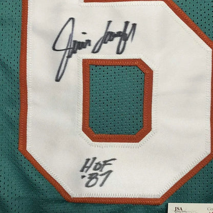 Signed Miami Dolphins jersey with Hall of Fame inscription and photos displayed