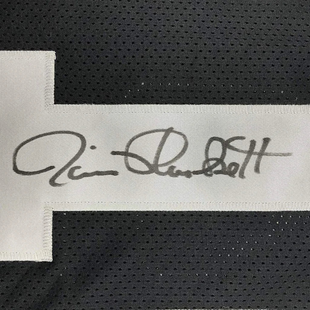 Black mesh football jersey with white signature label featured on framed autographed jim plunkett oakland jersey