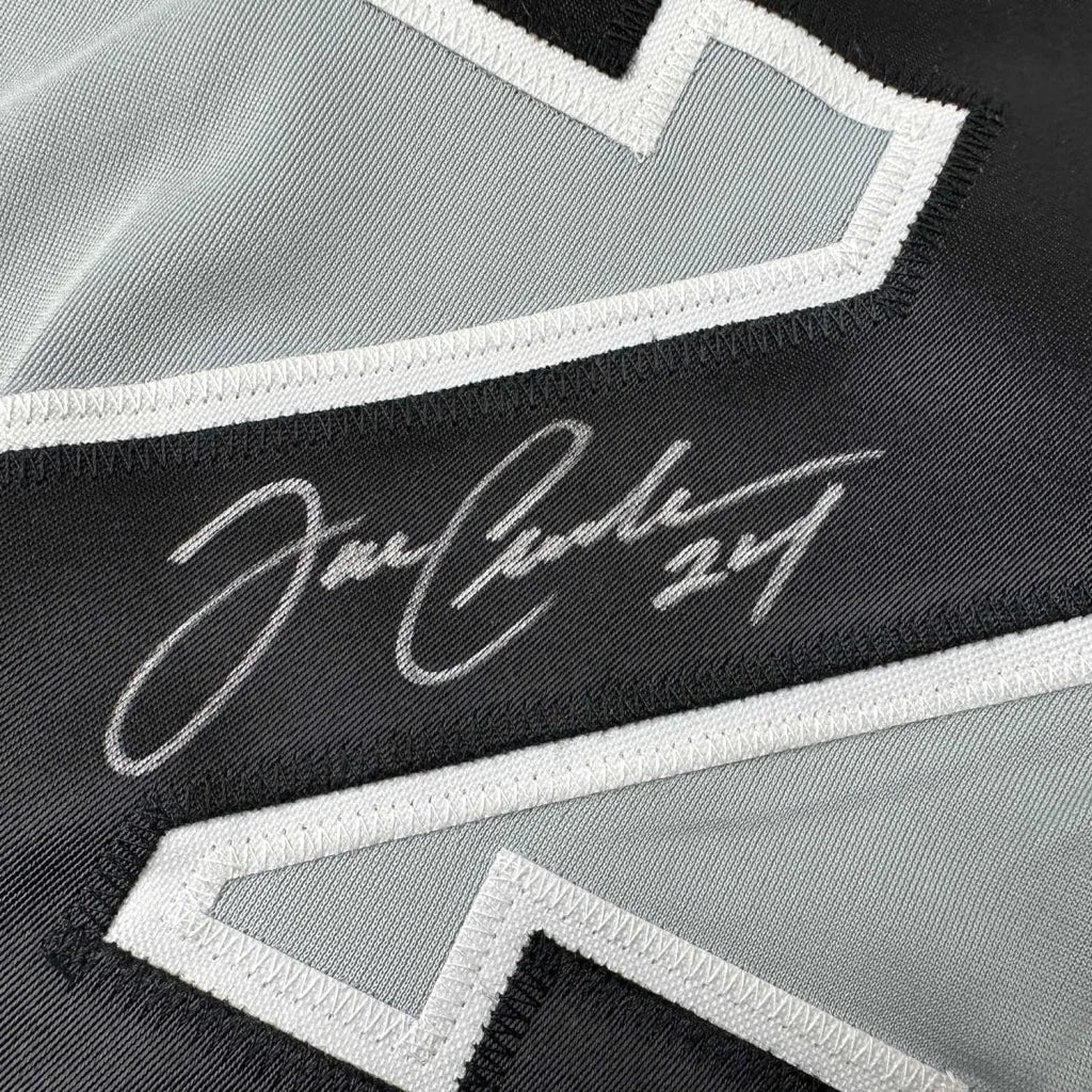 Autographed black and gray baseball jersey with player photos ready to display