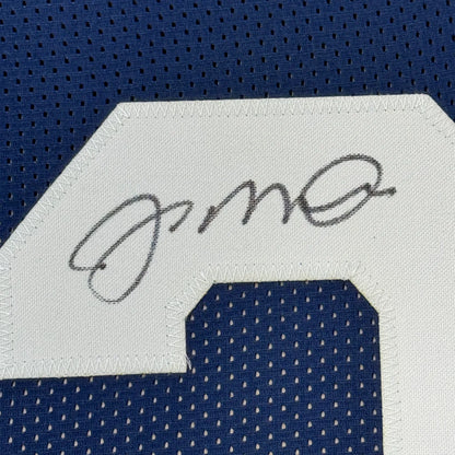 Autographed Notre Dame Blue Jersey with 5x7 Photos of Joe Montana displayed in frame