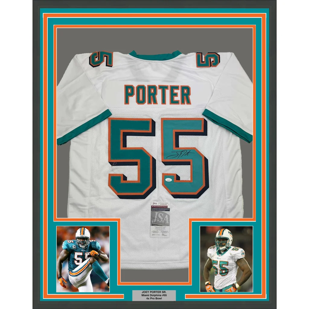 Autographed Miami Dolphins football jersey with player photos in a framed display
