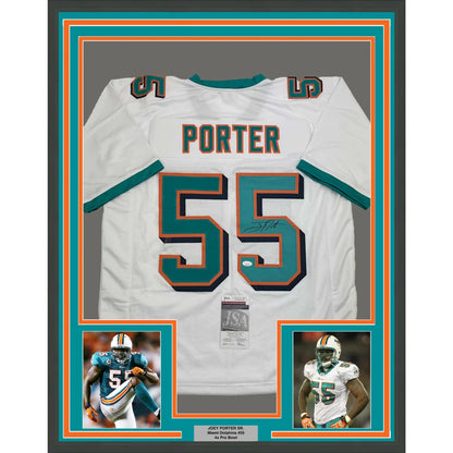 Autographed Miami Dolphins football jersey with player photos in a framed display