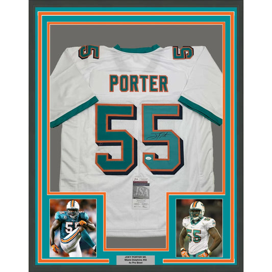 Autographed Miami Dolphins football jersey with player photos in a framed display