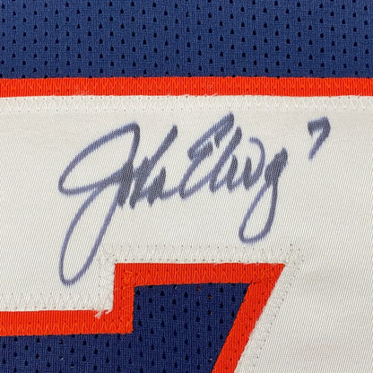 Framed autographed white and blue denver football jersey with orange trim signed above number 7 by john elway