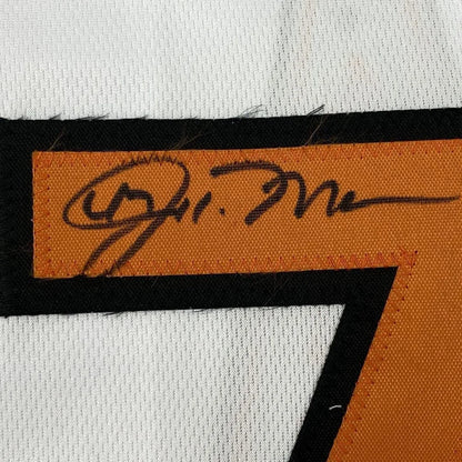 Autographed orange fabric swatch on a white Baltimore baseball jersey in a professional frame