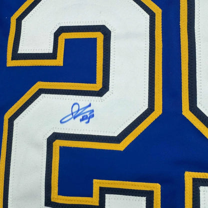 Blue and white hockey jersey with gold trim and a blue autograph, perfect for fans