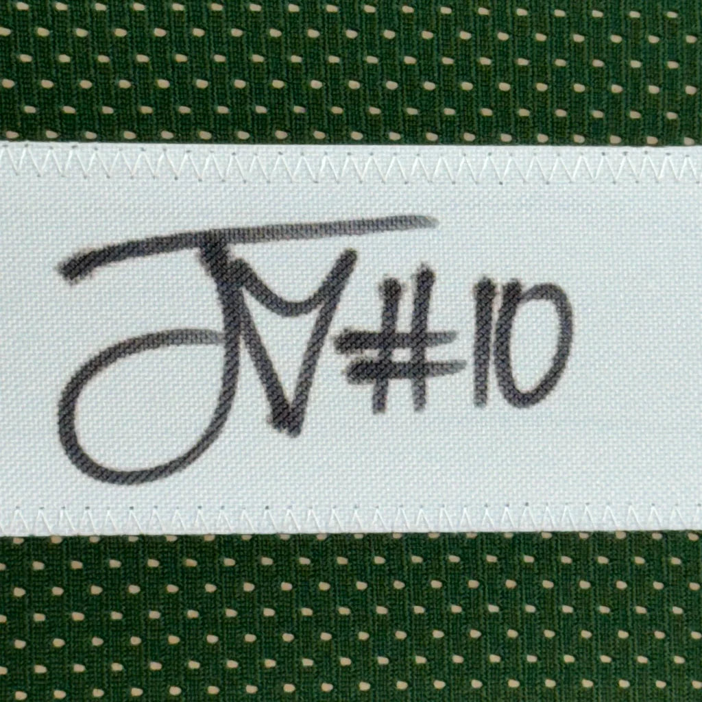 Green fabric with white polka dots and sewn white label on Autographed Jordan Love Jersey