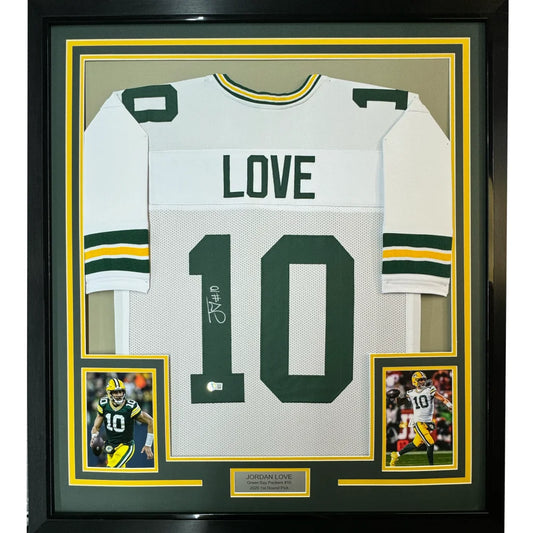 Back of a green and white framed jordan love football jersey with number 10 and signature below the number