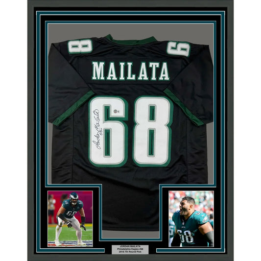 Framed autographed black philadelphia eagles football jersey with green and white accents featuring name mailata number 68 signed by jordan mailata back side