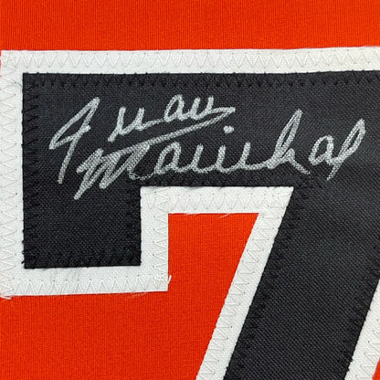 Black and red sports jersey patch with white stitched border and silver embroidered signature above number 7