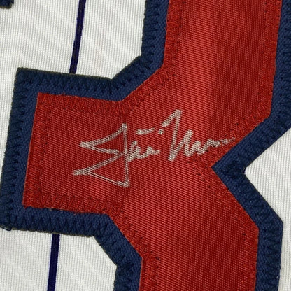 Red and blue fabric patch with silver signature on Justin Morneau Signed Jersey Display