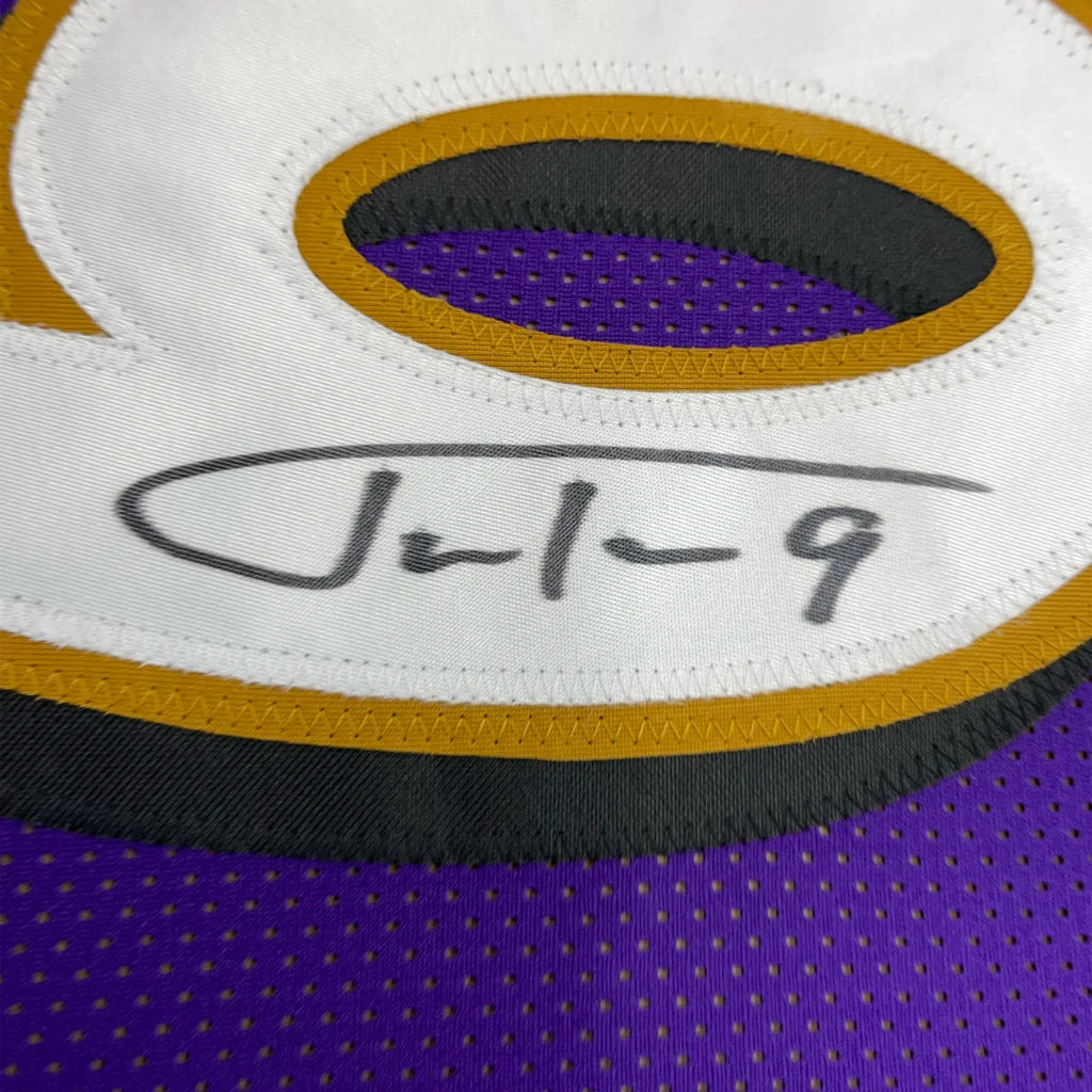 Purple and gold Justin Tucker Ravens signed jersey with photos in a framed display