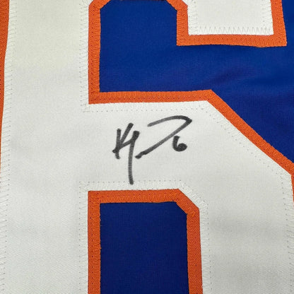 Blue and white Ken Morrow Islanders jersey with orange trim and black autograph for display