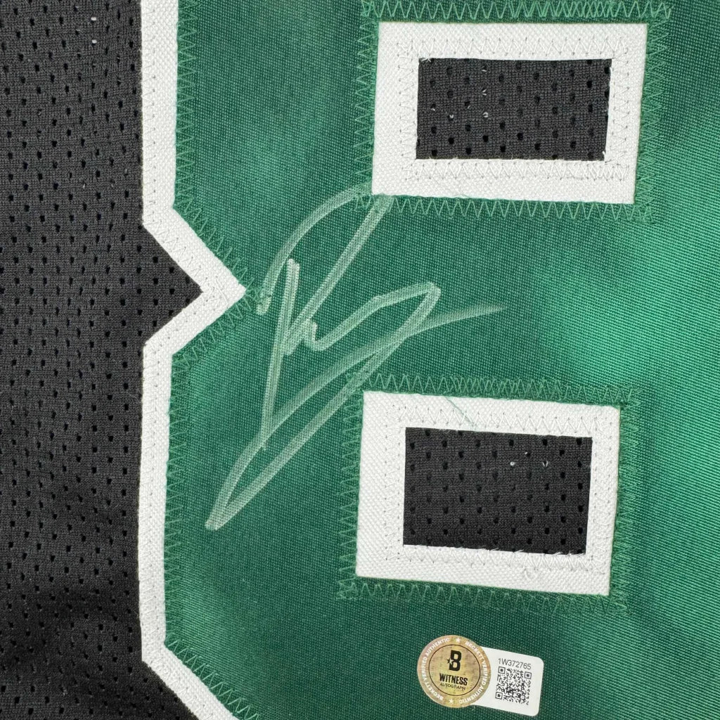 Green Boston Celtics jersey with white numbers and Kristaps Porzingis autograph