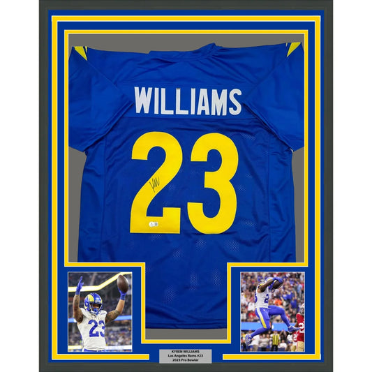Autographed blue and yellow sports jersey with player photos in a frame for display