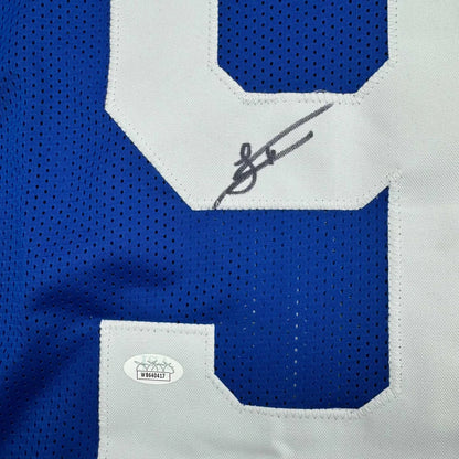 Blue Indianapolis Colts Latu jersey with white numbers and autograph ready to hang