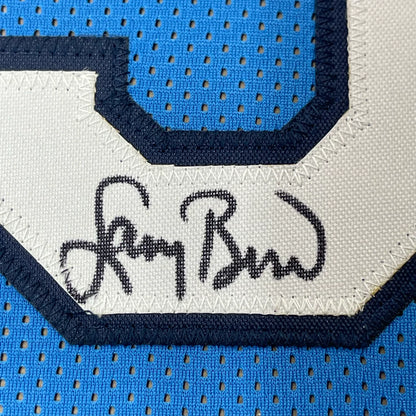 Light blue Larry Bird signed sports jersey with white number and autograph for display