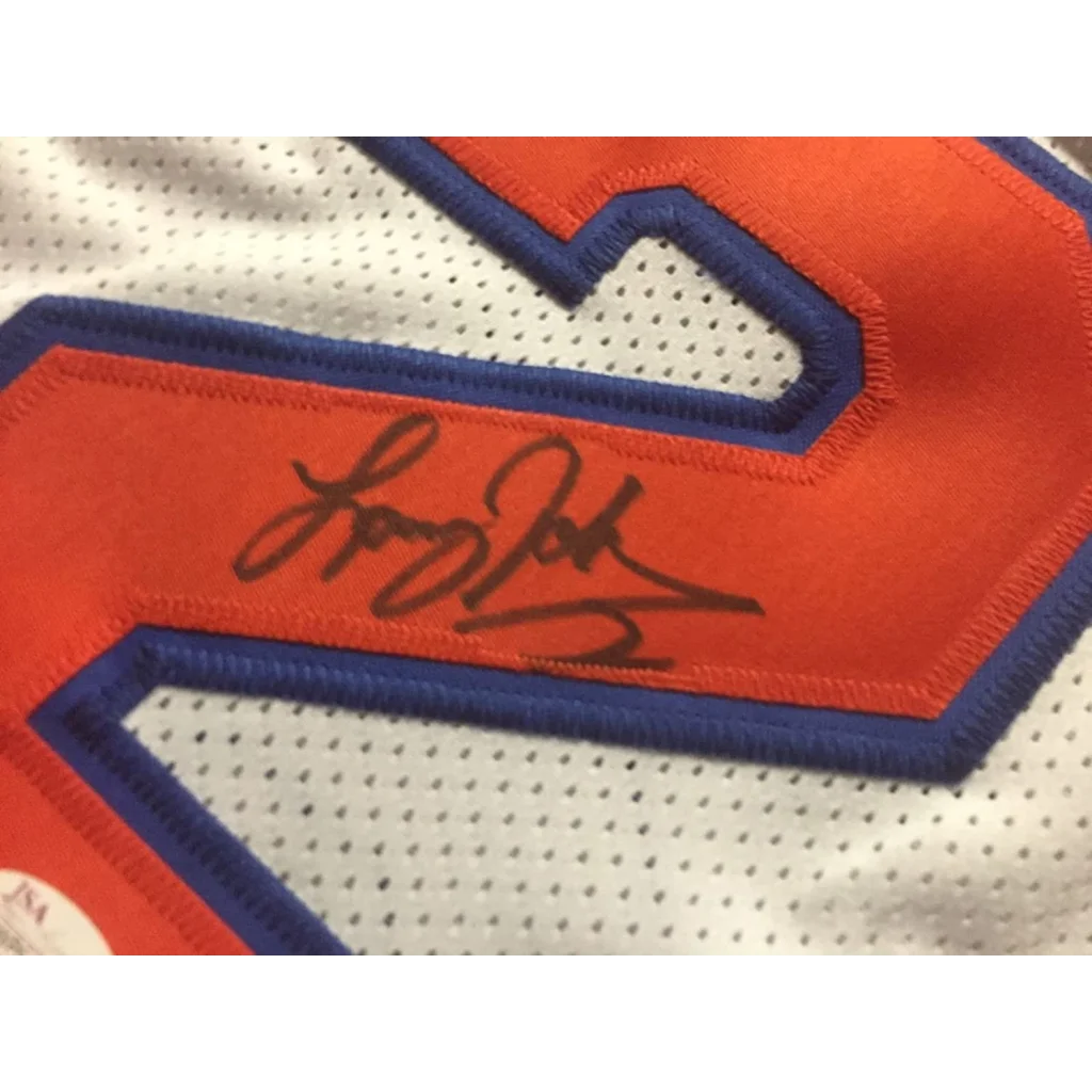 White Knicks jersey with orange and blue numbers, signed by Larry Johnson with JSA sticker