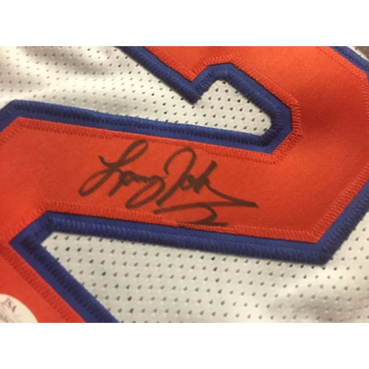 White Knicks jersey with orange and blue numbers, signed by Larry Johnson with JSA sticker