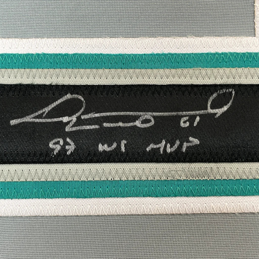 Black fabric label with white embroidered signature and text on framed autographed livan hernandez baseball jersey