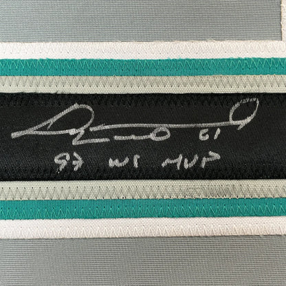 Black fabric label with white embroidered signature and text on framed autographed livan hernandez baseball jersey