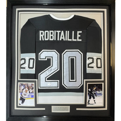 Framed autographed Luc Robitaille HOF black LA Kings jersey with name and number 20