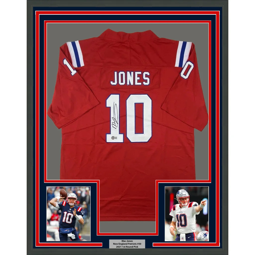 Back of framed autographed Mac Jones red Patriots jersey with number 10, name Jones, stripes on sleeves, Beckett BAS COA