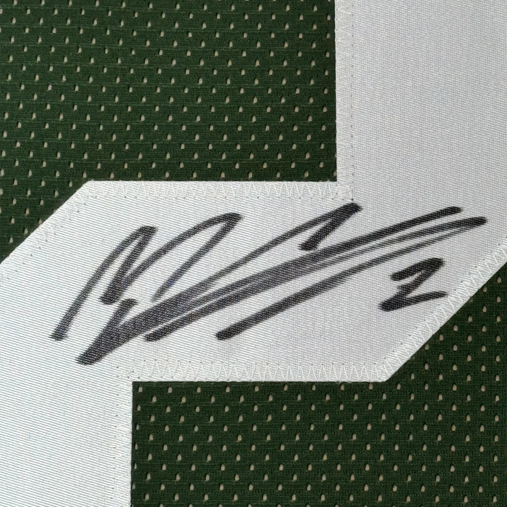 Black ink Mason Crosby signature on white patch of framed Green Bay jersey