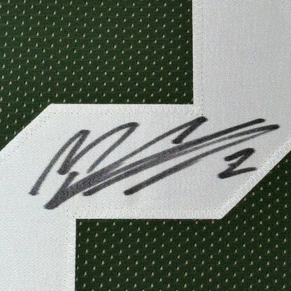 Black ink Mason Crosby signature on white patch of framed Green Bay jersey