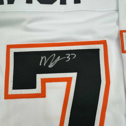 White McTavish signed hockey jersey with black and orange number 7 and autograph