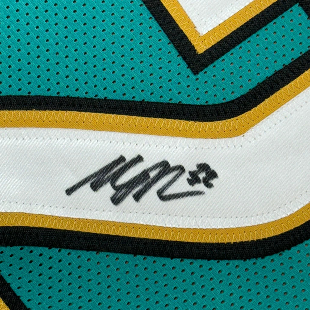 Autographed teal and white Maurice Jones Drew Jaguars jersey with gold and black trim