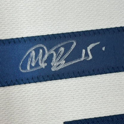 Blue woven label with white embroidered signature on framed Megan Rapinoe USA World Cup jersey