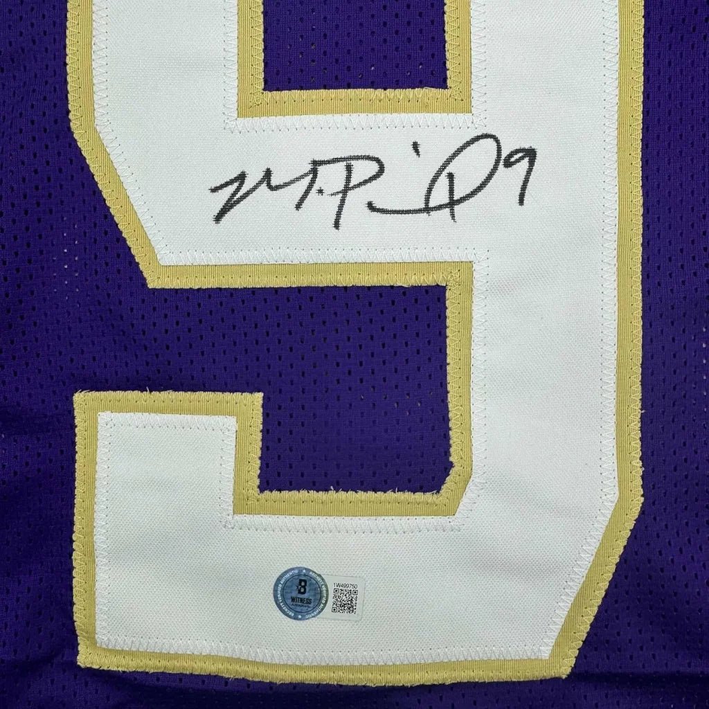Framed autographed purple and white mesh washington huskies football jersey with gold trim signed number nine