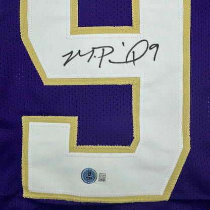 Framed autographed purple and white mesh washington huskies football jersey with gold trim signed number nine