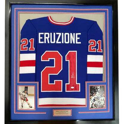 Back of a framed autographed mike eruzi blue and red 1980 miracle on ice united states hockey jersey with name and number 21