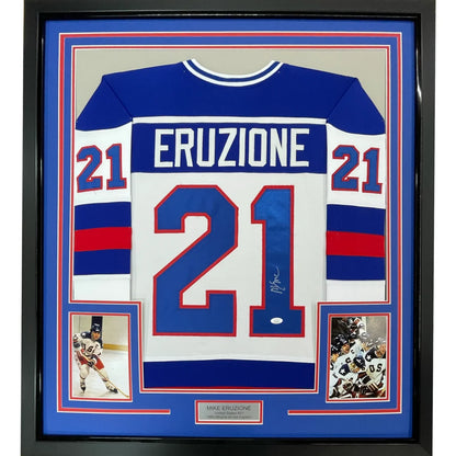 Framed autographed mike eruziu blue and white hockey jersey with red accents in black border 35x39 inches
