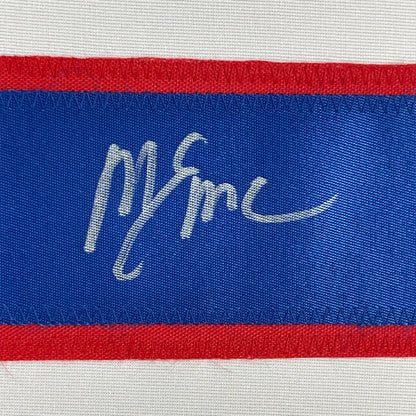 Blue and red woven label with white embroidered m and c signature on framed autographed mike eruzione 1980 hockey jersey