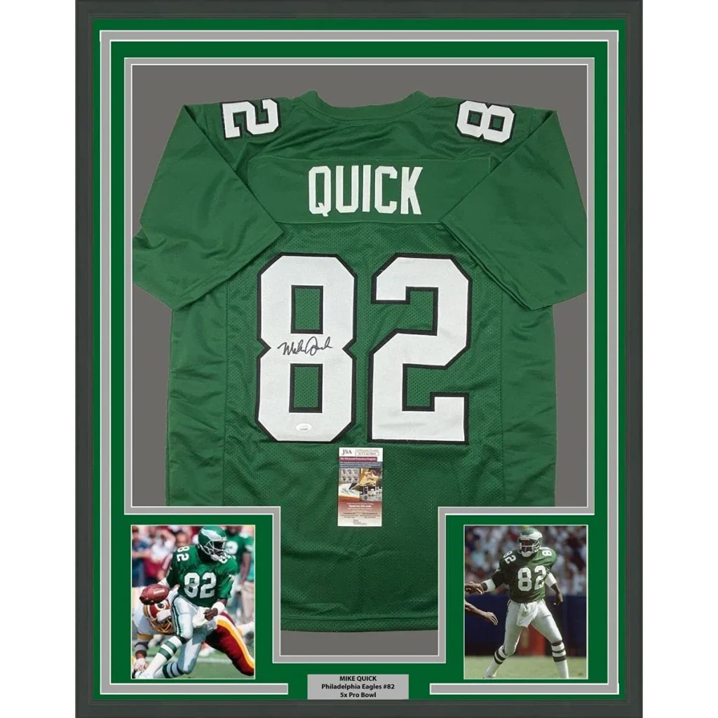 Back side of a framed autographed mike quick philadelphia eagles green football jersey with white number 82 and coa