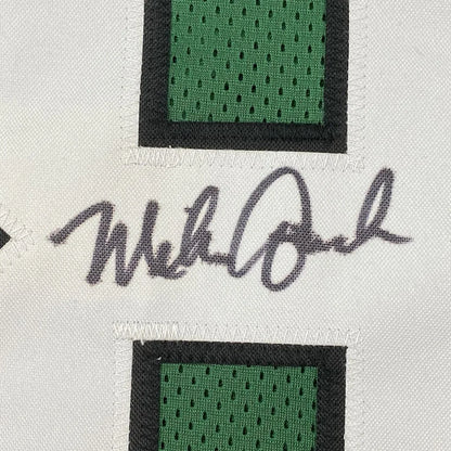 Framed autographed mike quick white football jersey with green mesh panels black trim and gray ink signature