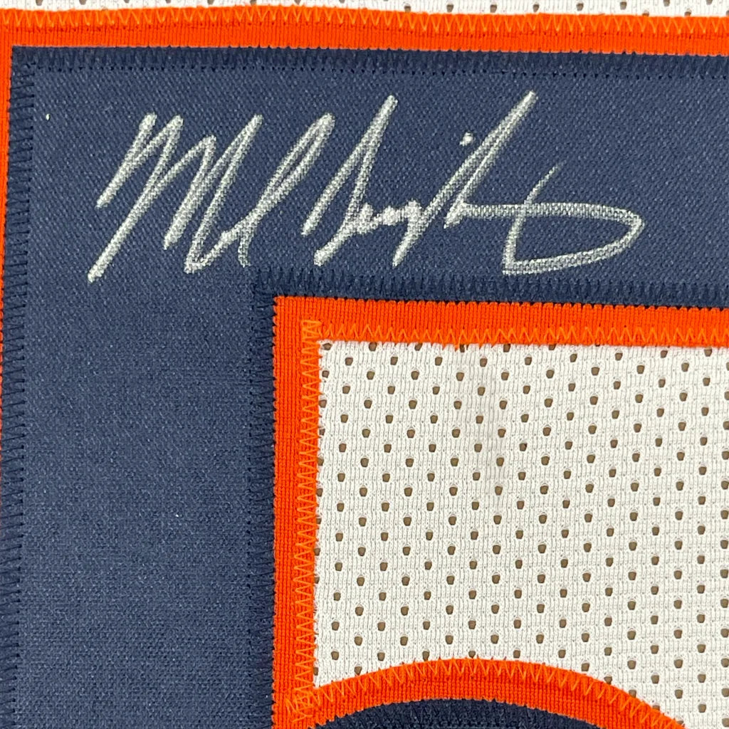 Autographed Number 50 Football Jersey with action photos in a frame for display