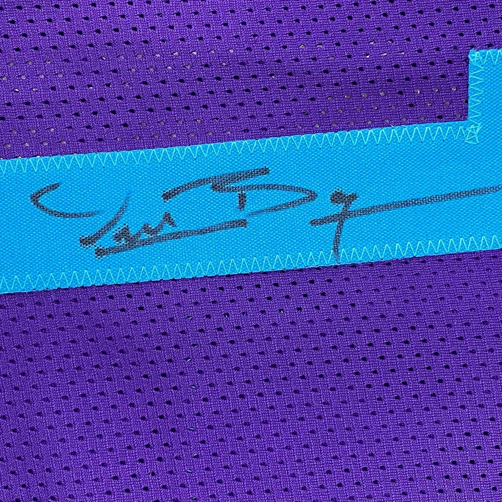 Purple mesh fabric with vibrant blue zig-zag edged strip and Muggsy Bogues signature