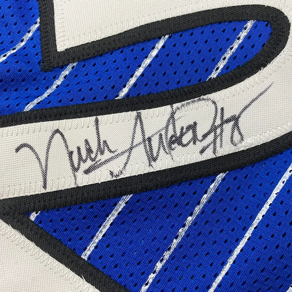 Framed autographed Nick Anderson Orlando blue pinstripe basketball jersey with black trim and signature across chest
