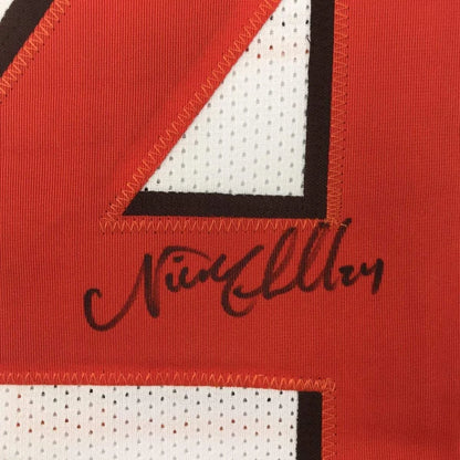 Framed autographed cleveland white football jersey with red white and black mesh fabric featuring number 4 in bold design