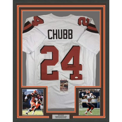 Back side of a framed autographed white cleveland browns football jersey with red number 24 and black lettering signed