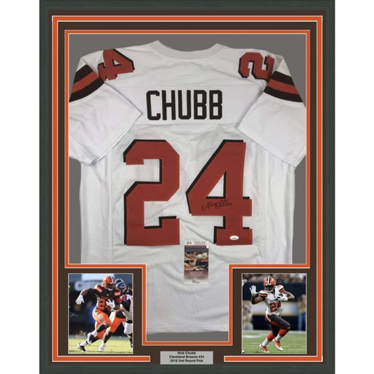 Back side of a framed autographed white cleveland browns football jersey with red number 24 and black lettering signed