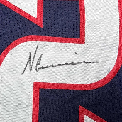 A navy blue white and red mesh basketball jersey signed by Nico Collins displayed in a framed 35x39 Houston rookie jersey